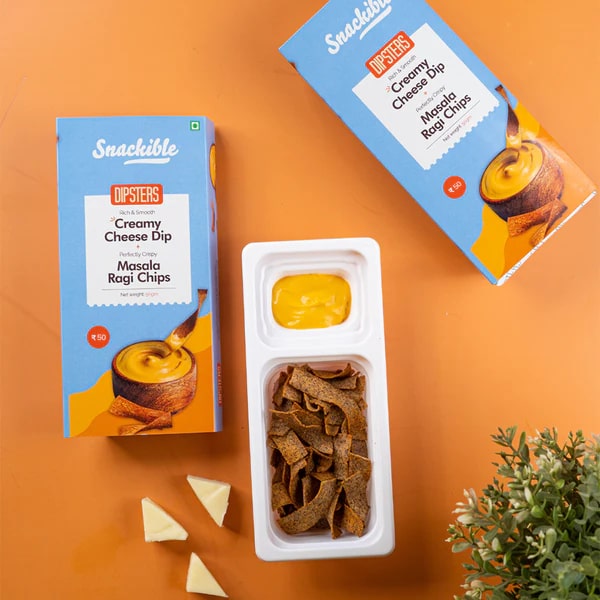 Carton pack of masala ragi chips with creamy cheese dip